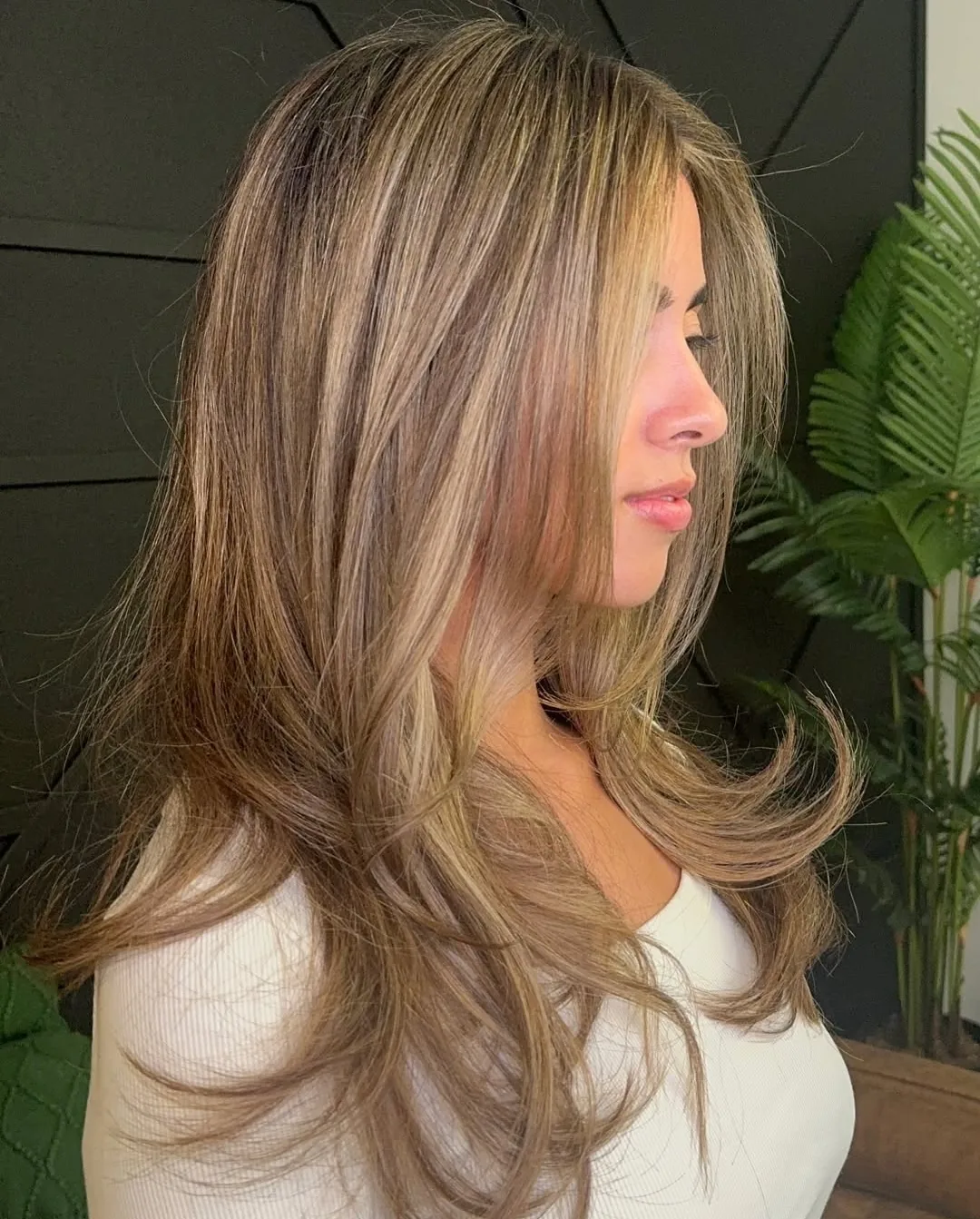 Golden blonde highlights worn loose over one shoulder, brushed out to show the dimension through the mid lengths.